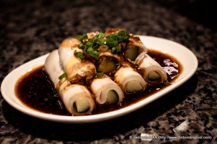 Thin slices of Pork Belly rolled over cucumbers. A Szechuan dish.